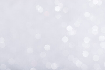 Silver glowing sparkles blurred background