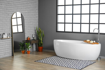 Interior of grey bathroom with mirror