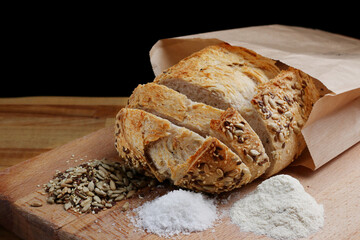 whole wheat sliced bread with seed on wooden board. Freshly baked traditional bread on wooden table. Healthy food