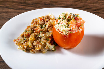 Tabbouleh Salad with stuffed tomato. Vegetarian food. Traditional middle eastern or Arab dish. Top view