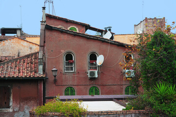 Old red residential building in the city centre of Rome, Italy.