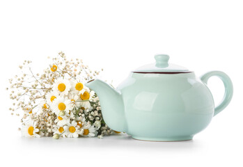 Teapot of tasty tea and chamomile flowers on white background