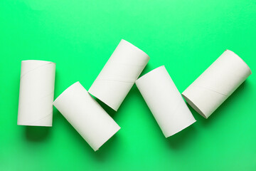 Toilet paper cardboard tubes on green background