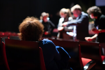 audience taking seats before theatre performance