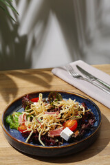 tuna salad with feta and tomatoes closeup on wooden table