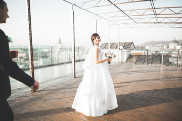 Obraz premium Gorgeous wedding couple walking in the old city of Lviv