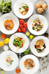 dinner concept. table with food top view many dish with ingredients on concrete background. light concrete background. summer food selection
