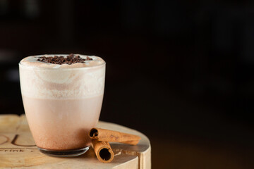 hot cocoa on wooden table closeup with copy space on dark background