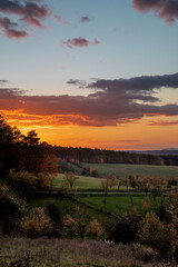 vertical photo of fall countryside with sunset sky over the country