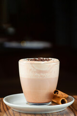 hot cocoa on wooden table closeup with copy space on dark background