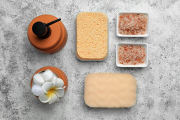 Bath supplies with sponges on grunge background