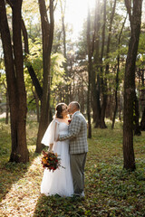 walk of the bride and groom through the autumn forest