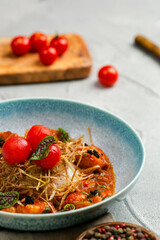 griiled shrimp with tomatoes sauce and rice close up in plate on concrete table with ingredients on background