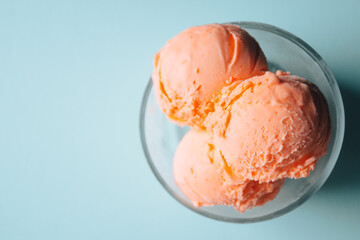 Orange Sherbet Scoops in a Glass Bowl