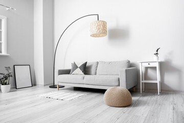 Interior of light living room with textile pouf