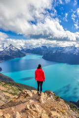 Obraz premium Adventurous Caucasian Woman hiking on top of a Canadian mountain. Taken on Panorama Ridge, Garibaldi, Near Whister and Squmish, North of Vancouver, BC, Canada.