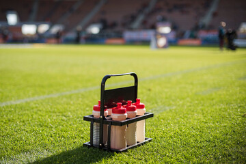 Set of isotonic drinks on the soccer field at the stadium