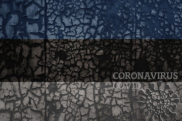 flag of estonia on a old metal rusty cracked wall with text coronavirus, covid, and virus picture.