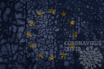 flag of european union on a old metal rusty cracked wall with text coronavirus, covid, and virus picture.