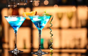 Glasses of Blue Lagoon cocktail on table in bar