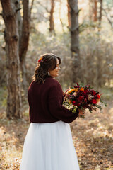 girl in a wedding dress in the autumn forest