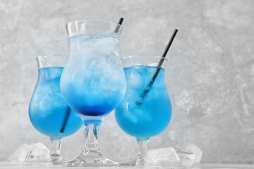 Glasses of Blue Lagoon cocktail on table, closeup