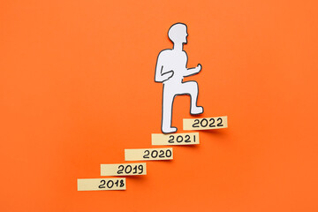 Figures denoting years 2018-2022 and paper man on color background