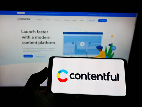STUTTGART, GERMANY - Aug 02, 2021: Person holding smartphone with logo of company Contentful Inc. on screen in front of website.