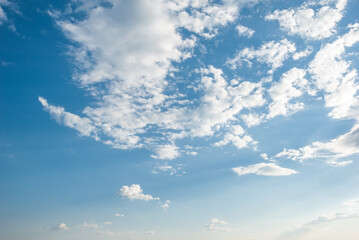 Blue sky background with tiny clouds.