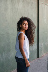 Portrait of a teenage cuban woman girl from the back turning her face to the camera