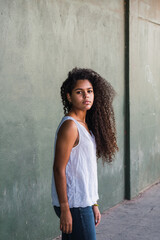 Portrait of a teenage cuban woman girl from the back turning her face to the camera