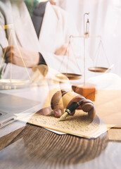 Business and lawyers discussing contract papers with brass scale on desk in office. Law, legal services, advice, justice and law concept picture with film grain effect