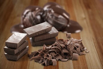 Composition of bars and pieces of different milk and dark chocolate on the desk