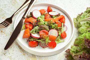 Plate with fresh salad on light background, closeup
