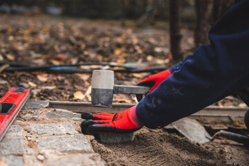 Construction worker using a rubber hammer