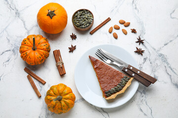 Autumn composition with piece of tasty pumpkin pie on light background