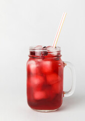 Mason jar with healthy cranberry juice on light background