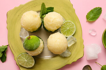 Plate with tasty ice creams in lime peels on color background