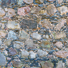 Old stone wall made of large and small stones as a natural background