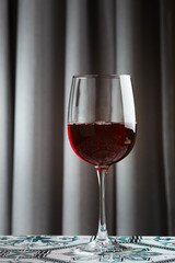 glass of red wine on tile table closeup