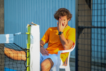 Portrait of a disappointed padel player after a lost to padel or tennis game - Handsome player...
