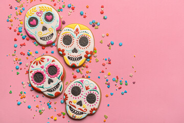 Skull shaped cookies and topping on pink background. El Dia de Muertos