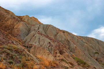 Mountain hills against the sky on a cloudy autumn day
