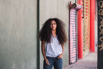 Portrait of a teenage cuban girl looking to the camera, closeup latin cuban teenage woman