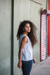 Portrait of a teenage cuban girl looking to the camera, closeup latin cuban teenage woman