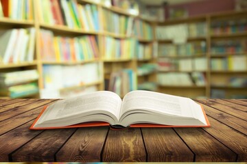 Open book on old wooden table in the library