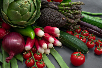 Different organic vegetables - asparagus, tomatoes cherry, avocado, artichoke, pepper, lime,...