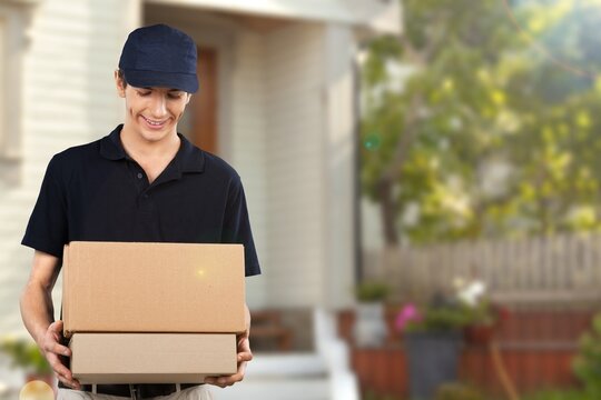 Home Delivery Man Delivering Packages At Door.