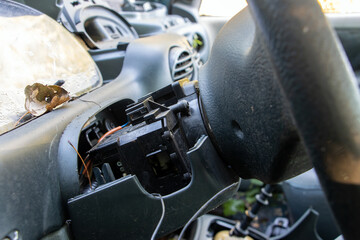 Fototapeta na wymiar A part of steering wheel with dashboard of damaged car