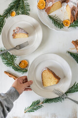 Hand holding a plate of cake slices on white background